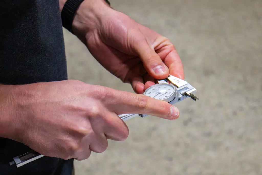 Quality control inspection of a machined component at Grover Precision